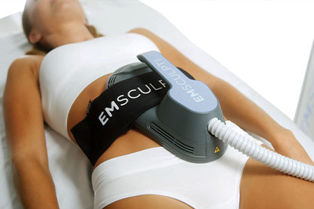 patient receiving emsculpt treatment in Orange